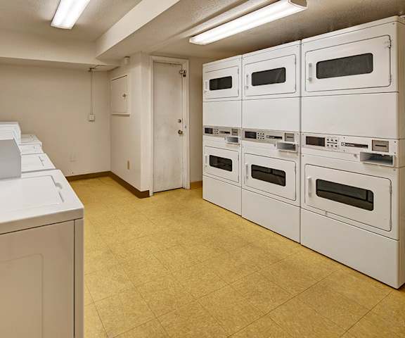 The laundry room with washers and dryers at Rancho Tudor Apartment Homes.