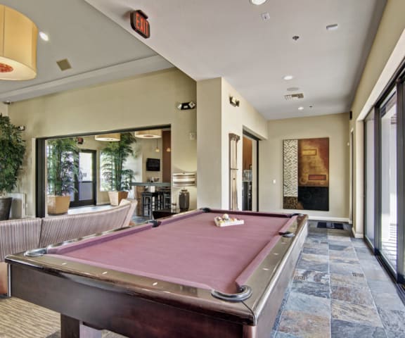 a pool table in the clubhouse at cobblestone apartments