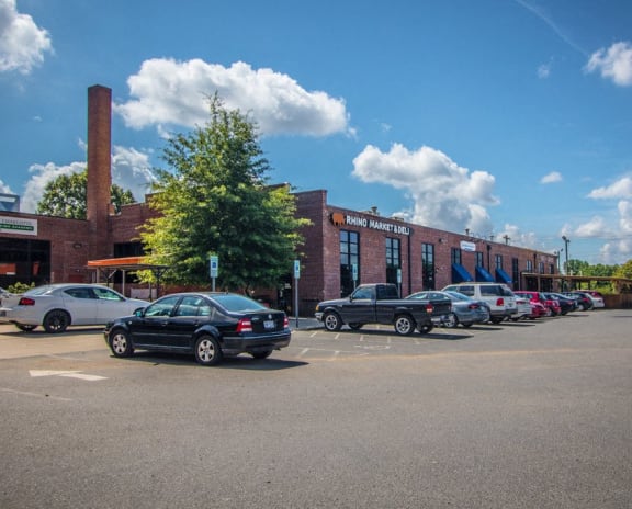 a parking lot with cars in front of a brick building