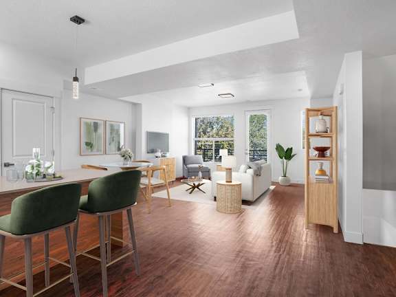 A modern kitchen with green barstools and a wooden floor.