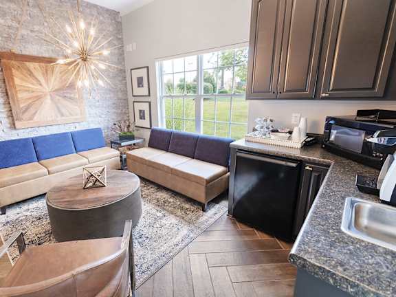 A kitchen with a blue couch and a wooden table.