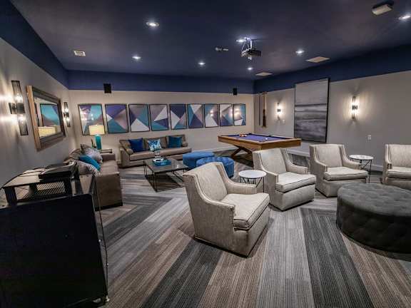A modern living room with a pool table and comfortable seating.