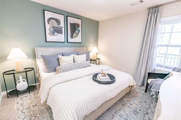 a bedroom with a bed and two windows
