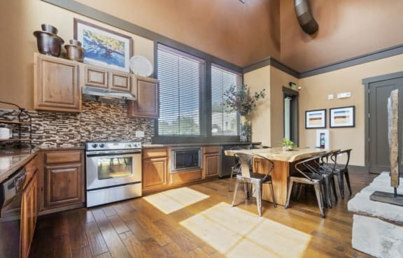 a kitchen with wooden cabinets and a dining table