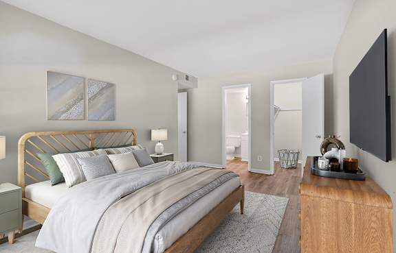 A bedroom with a large bed and a wooden dresser.
