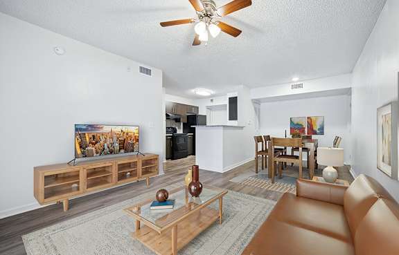A living room with a brown leather couch and a wooden coffee table.