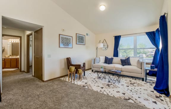 Open Living Room With Lots Of Natural Light & Vaulted Ceilings