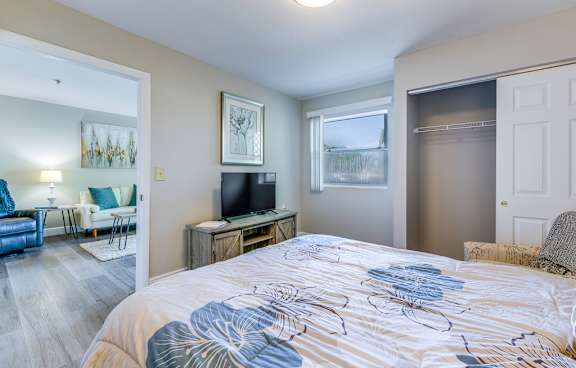 Bedroom with a large bed at Aventine at Lantana - 55+ Active Adult Apartments, Florida, 33462