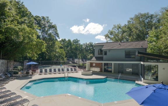 a swimming pool with a house in the background