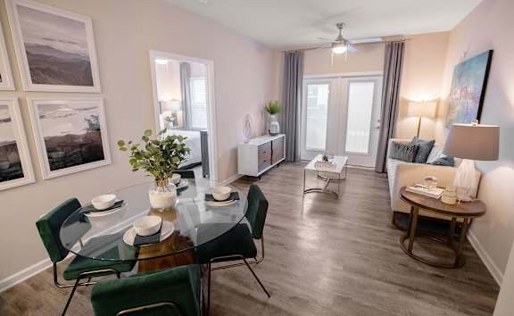 A dining room with a glass table and chairs.