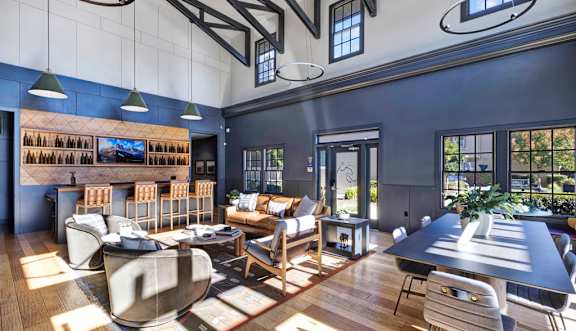 A modern living room with a dark blue wall and a large window.