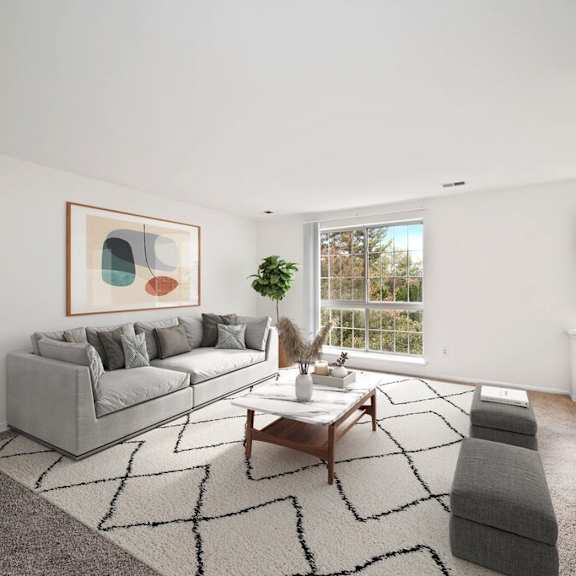 A living room with a grey sofa, a coffee table, and a large abstract painting on the wall.