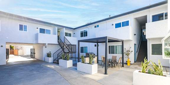 A beautiful beach scene with palm trees and flowers in the foreground.