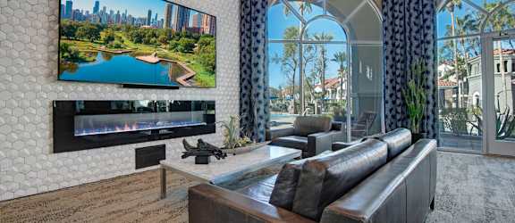 A modern living room with a large TV displaying a cityscape.