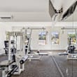 gym with stylish floor and TV at The Village at Sun Valley Apartments, Mesa