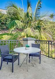 Balcony with a table and chairs at Azure Point at Encinitas - 55+ Active Adult Apartments, Encinitas, California