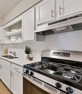 a kitchen with stainless steel appliances and white cabinets