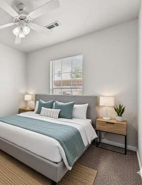 an empty room with carpet and a ceiling fan