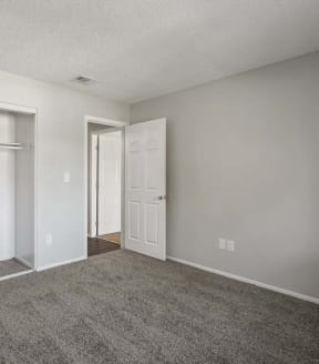 a bedroom with two doors and a carpeted floor at Aspire Redlands, Redlands, 92374