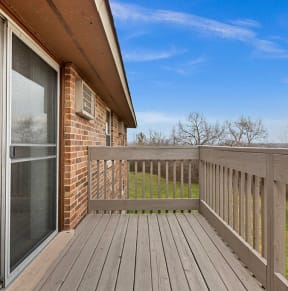 the deck of a home with a sliding glass door