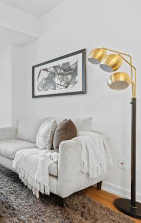 A living room with a white couch and a television.