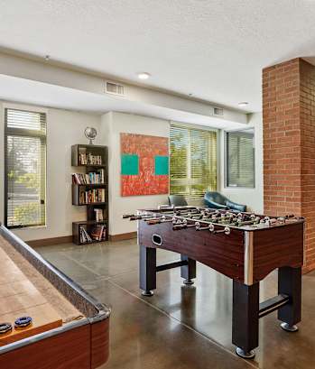 a game room with a foosball table and a pool table