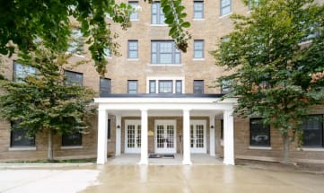 a large brick building with white pillars in front of it