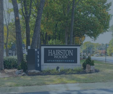 a sign that says harrison woods apartments