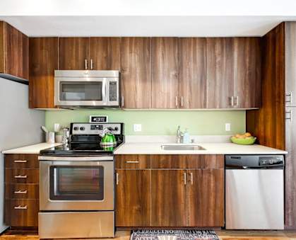 a kitchen with wooden cabinets and stainless steel appliances