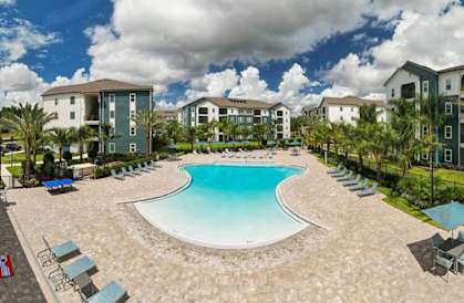 an aerial view of a resort style pool with lounge chairs and umbrellas at Fountainhead, Jacksonville, Florida, 32258
