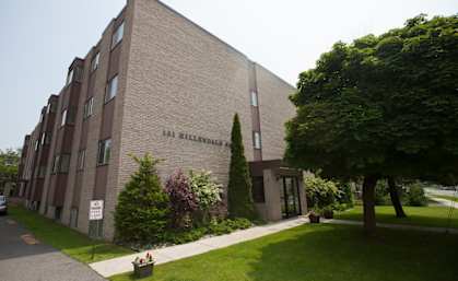a large brick building with trees in front of it