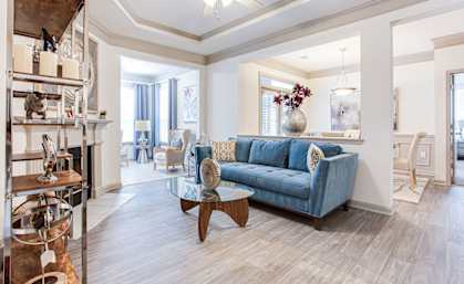 a living room filled with furniture and a ceiling fan