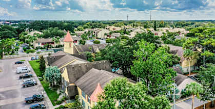 A sunny day in a residential area with houses and trees.