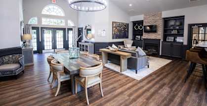 A modern dining room with a glass table and chairs.