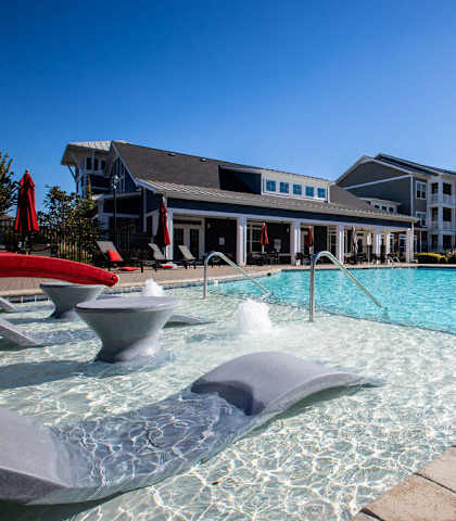apartments with a large swimming pool in front of a building