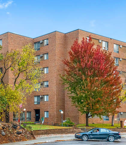 A brick building with trees in front of it.
