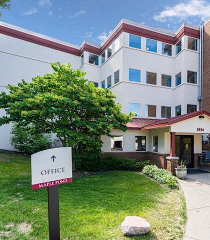 the front entrance of the office building apartments