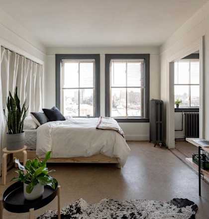 a bedroom with a bed and a window
