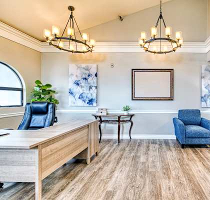 A living room with a blue couch and a wooden table.