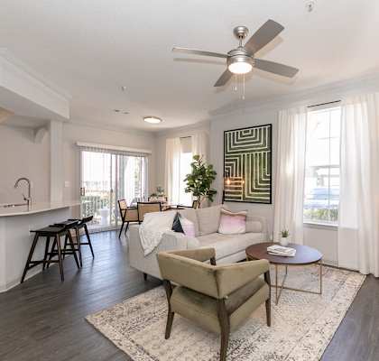 a living room with a couch and a ceiling fan at Deerfield Village, Alpharetta