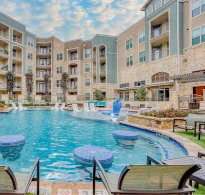 a swimming pool with lounge chairs at The Mark, San Antonio, TX