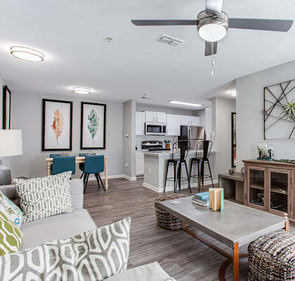 an open living room and kitchen with a ceiling fan  at Peaks at Gainesville, Gainesville, GA