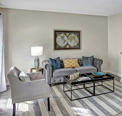 a living room with a couch coffee table and a dresser