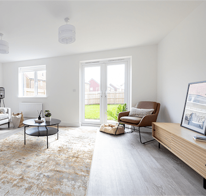 A living room with a grey sofa, a coffee table, and a chair.