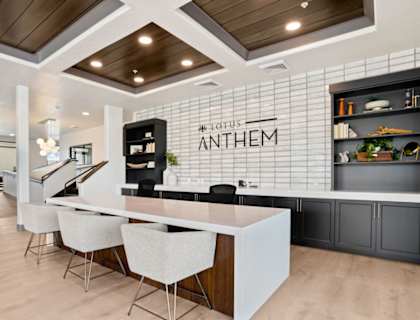 a kitchen with a long island with a white countertop