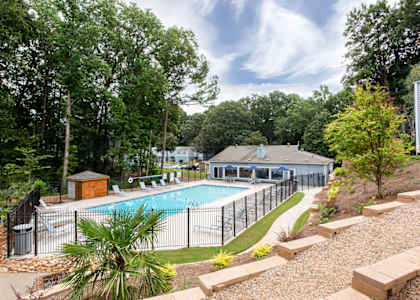 a swimming pool with a fence around it at The Cobb Apartments-Townhomes, Austell