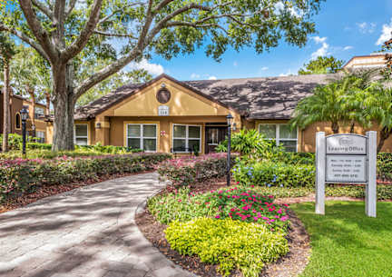 A leasing office is located in a building with a landscaped front yard.