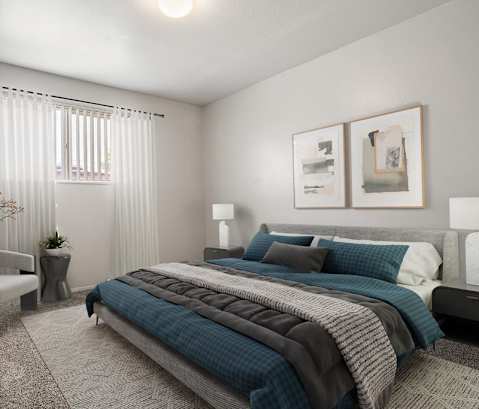 a bedroom with a bed and two pictures on the wall