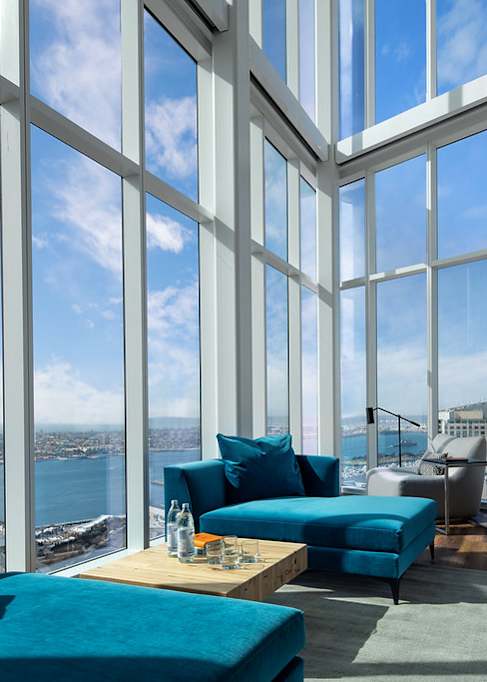 A living room with a view of the cityscape.