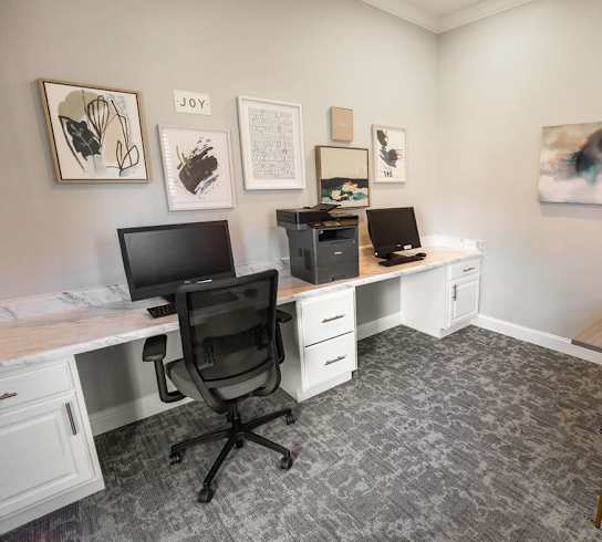 A room with a desk, chair, and computer.